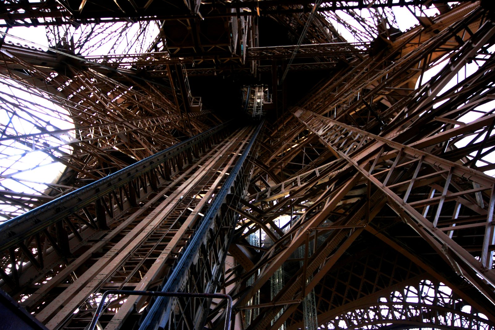 Looking into the interconnected steel structure of the Eiffel Tower.