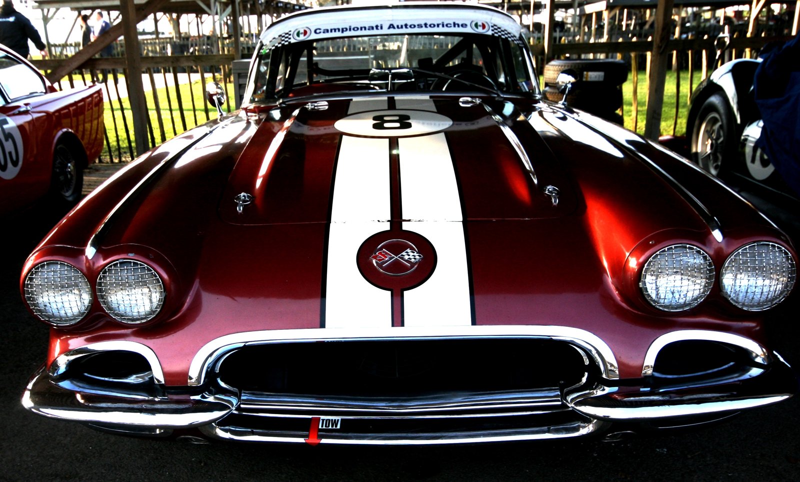 A historic sports car with its front section open at Goodwood.